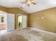 Bedroom features a ceiling fan and adjoins a laundry room and bathroom at 8576 Sandy Beach St, Tampa, FL 33634