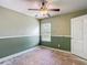 Bedroom with two-tone walls and a ceiling fan fixture at 8576 Sandy Beach St, Tampa, FL 33634