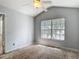 A well-lit bedroom with a ceiling fan and natural light coming through a large window at 8576 Sandy Beach St, Tampa, FL 33634