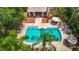 Beautiful community pool with inviting lounge areas, mature landscaping, and shaded seating for relaxation at 8576 Sandy Beach St, Tampa, FL 33634