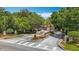 Welcoming community entrance with lush landscaping, an attractive sign, and well-maintained roadways at 8576 Sandy Beach St, Tampa, FL 33634