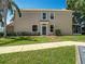 Two-story home featuring a green front door, large windows, and lush landscaping at 8576 Sandy Beach St, Tampa, FL 33634