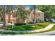 Two story townhome with green lawn and bushes with a palm tree in the front at 8576 Sandy Beach St, Tampa, FL 33634