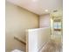 The second story hallway features an off white bannister, and leads to bedrooms at 8576 Sandy Beach St, Tampa, FL 33634