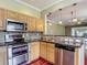 Modern kitchen with stainless steel appliances, hardwood floors and granite countertops at 8576 Sandy Beach St, Tampa, FL 33634