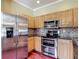 Well-equipped kitchen with stainless steel appliances, tiled backsplash and ample cabinetry at 8576 Sandy Beach St, Tampa, FL 33634