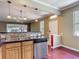 Open-concept kitchen with tile backsplash, a stainless steel dishwasher, and wood floors at 8576 Sandy Beach St, Tampa, FL 33634