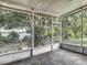 Screened lanai offering a view of the backyard and lake at 8576 Sandy Beach St, Tampa, FL 33634