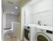 Upstairs laundry room with appliances and shelving at 8576 Sandy Beach St, Tampa, FL 33634