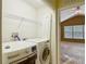 Laundry room with washer, dryer, and wire shelving at 8576 Sandy Beach St, Tampa, FL 33634