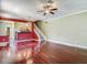 Open-concept living room with hardwood floors and view of kitchen and stairway at 8576 Sandy Beach St, Tampa, FL 33634