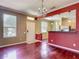 Open-concept living room featuring hardwood floors, front door and bar to kitchen at 8576 Sandy Beach St, Tampa, FL 33634
