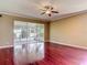 Open living room with hard wood flooring and sliding doors to the lanai at 8576 Sandy Beach St, Tampa, FL 33634