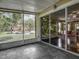 Enclosed patio with tile flooring, sliding glass doors lead to the interior space, and exterior views at 8576 Sandy Beach St, Tampa, FL 33634