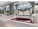 A bathtub nook with a large, diamond-pane window and a red tub at 8827 Scout Lake Ct, New Port Richey, FL 34654