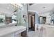 A spacious bathroom featuring a vanity, makeup table, toilet, and bathtub at 8827 Scout Lake Ct, New Port Richey, FL 34654