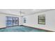 Bright room with pool view through sliding glass doors, and carpeting at 8827 Scout Lake Ct, New Port Richey, FL 34654