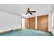 A spacious bedroom with a ceiling fan and large closets at 8827 Scout Lake Ct, New Port Richey, FL 34654