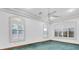 Spacious bedroom with three windows featuring elegant trim and shutters at 8827 Scout Lake Ct, New Port Richey, FL 34654