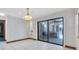 A bright dining area has tile floors and sliding doors that lead outside at 8827 Scout Lake Ct, New Port Richey, FL 34654