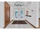Elegant entryway showcases double doors with decorative glass, tile flooring, and natural light at 8827 Scout Lake Ct, New Port Richey, FL 34654