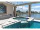 Inviting spa with a serene lake view at 8827 Scout Lake Ct, New Port Richey, FL 34654
