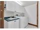 Well-lit laundry room featuring tile flooring, a sink, and a washer and dryer at 8827 Scout Lake Ct, New Port Richey, FL 34654