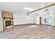 Spacious living area featuring a stone fireplace, wood floors, and a bright, open floor plan at 8827 Scout Lake Ct, New Port Richey, FL 34654