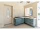 Enclosed outdoor kitchen area features tile flooring, backsplash, cooktop, and stainless sink next to an exterior door at 8827 Scout Lake Ct, New Port Richey, FL 34654
