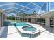 Inviting screened pool and spa with tiled accents in backyard at 8827 Scout Lake Ct, New Port Richey, FL 34654