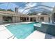 Large pool area with hot tub, glass fountain, and screened enclosure at 8827 Scout Lake Ct, New Port Richey, FL 34654