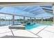 Relaxing screened-in pool area with a serene lake view at 8827 Scout Lake Ct, New Port Richey, FL 34654