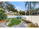 A landscaped backyard is fenced and features a fire pit and serene landscaping at 9408 Sayre St, Riverview, FL 33569