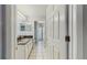 Bathroom with marble countertop, white cabinets, and white tiled floors at 9408 Sayre St, Riverview, FL 33569