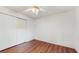 Bedroom featuring wood-look floors, a ceiling fan, and a double closet at 9408 Sayre St, Riverview, FL 33569