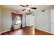 Bedroom with hardwood floors, ceiling fan, and a window with views of the outdoors at 9408 Sayre St, Riverview, FL 33569