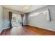 Bright bedroom with hardwood floors and sliding door access to the pool area, providing a seamless indoor-outdoor flow at 9408 Sayre St, Riverview, FL 33569