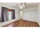 Bedroom featuring hardwood floors, a ceiling fan, and built in shelves for extra storage at 9408 Sayre St, Riverview, FL 33569