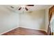 Bedroom featuring hardwood floors, ceiling fan, and a window overlooking the outdoors at 9408 Sayre St, Riverview, FL 33569