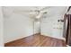 Spacious bedroom featuring hardwood flooring, a ceiling fan, and added shelving for extra storage at 9408 Sayre St, Riverview, FL 33569