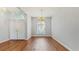 Bright entryway featuring hardwood floors, a chandelier and a decorative arched window at 9408 Sayre St, Riverview, FL 33569