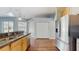 Kitchen with stainless steel appliances, granite counters and hardwood floors at 9408 Sayre St, Riverview, FL 33569