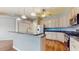 Kitchen with granite countertops, wooden cabinetry, stainless steel appliances and a breakfast bar at 9408 Sayre St, Riverview, FL 33569