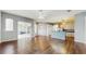 Bright, open floor plan showcases sliding glass doors leading to the patio with wood-style floors and a ceiling fan at 9408 Sayre St, Riverview, FL 33569