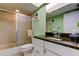 Bathroom featuring green walls, a shower/tub combo, and a granite countertop sink at 9484 Tara Cay Ct # 8, Seminole, FL 33776