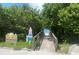 Wooden bridge leads to a beautiful beach through lush greenery, inviting a serene coastal experience at 9484 Tara Cay Ct # 8, Seminole, FL 33776