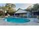 Enjoy this sparkling community pool with lounge chairs and a shaded seating area at 9484 Tara Cay Ct # 8, Seminole, FL 33776