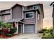 Charming two-story townhome with an attached garage and well-maintained landscaping. American flag present at 9484 Tara Cay Ct # 8, Seminole, FL 33776