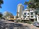 Tall buildings and restaurants offer outdoor seating, surrounded by lush greenery and palm trees at 9484 Tara Cay Ct # 8, Seminole, FL 33776