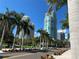 Palm trees line the street in front of luxurious high-rise condos at 9484 Tara Cay Ct # 8, Seminole, FL 33776